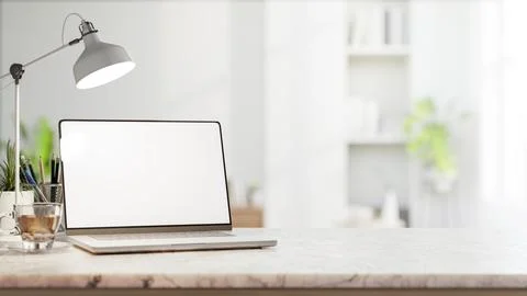 White screen laptop with coffee aside pencil storage and lamp on marble cou.. 스톡 일러스트
