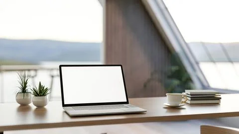 White screen laptop with coffee cup and books on wooden table in a glass wa.. イラスト素材