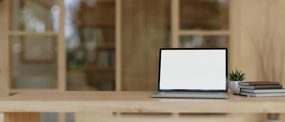 A white-screen laptop computer mockup on a wooden desk in a modern, Scandin.. Stock Illustration