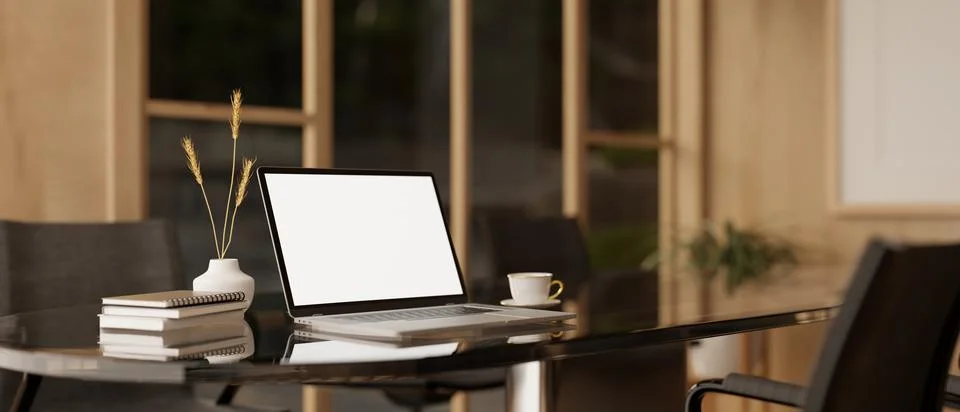 A white-screen laptop computer mockup and accessories on a meeting table in.. イラスト素材