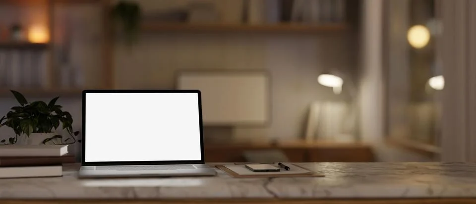 A white-screen laptop computer mockup on a white marble table in a cosy hom.. Stock Illustration