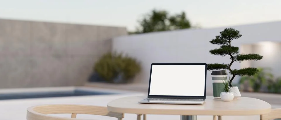 A white-screen laptop mockup on a table in a modern outdoor lounge on a roo.. Stock Illustration