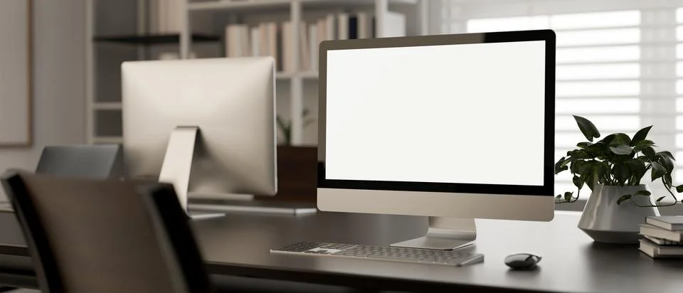A white-screen PC computer mockup on a desk in a modern office room. worksp.. 스톡 일러스트