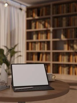 White screen tablet and keyboard with glasses and coffee on round table acr.. Illustrazione stock