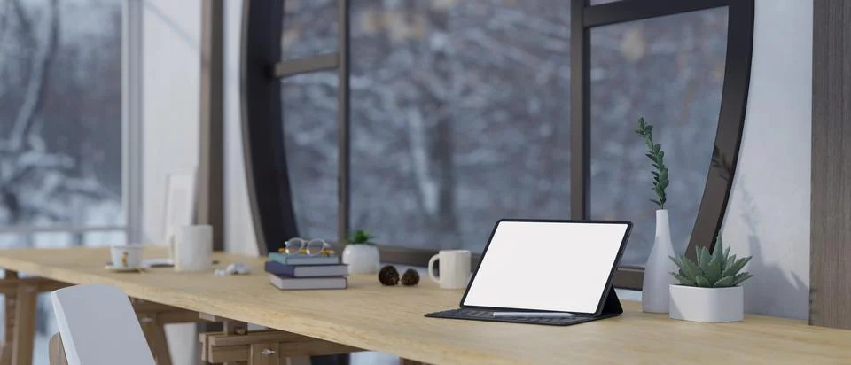 A white-screen tablet mockup with a wireless keyboard and stationery on a d.. Stock Illustration