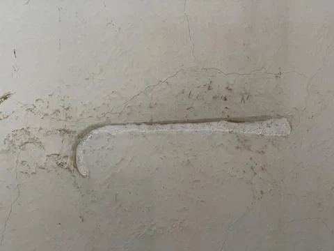 White scuff or patch mark on a textured cracked wall Stock Photos