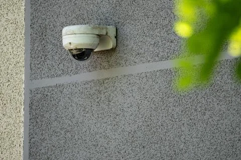 White Security Camera Mounted On Exterior Wall Of Building Stock Photos