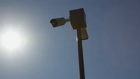 White security camera on pole in park or private area of large estate and Stock Footage 230314910