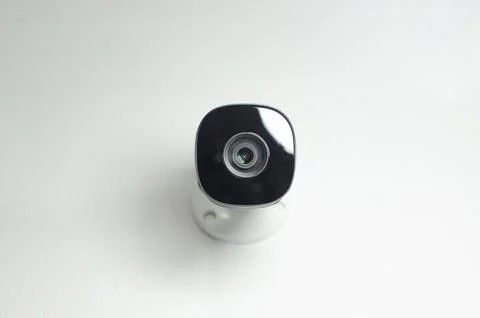 White security camera watchful eye, ensuring the surveillance and protectio.. 库存照片