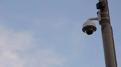 White security dome camera on pole, against blue sky Stock Footage 49587983