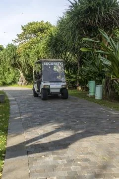 White security vehicle is driving down a road Stock Photos
