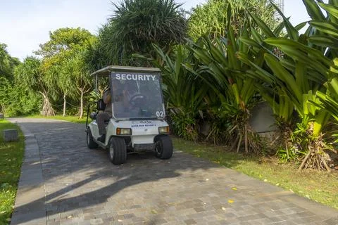 White security vehicle is driving down a road Stock-Fotos