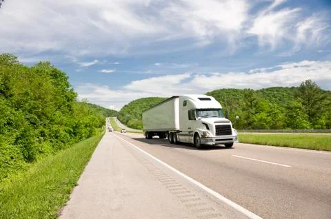 White Semi Truck On Highway In Springtime Stock Photos