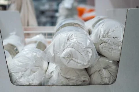 White set of bed linen rolls in decoration store Stock Photos