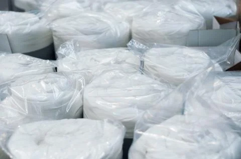 White set of bed linen rolls in decoration store Stock Photos