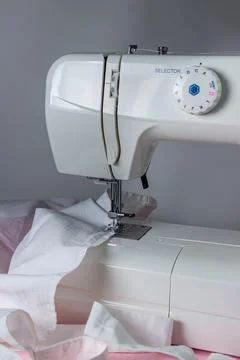White sewing machine on a pink background. Electric sewing machine. white fabric Stock Photos