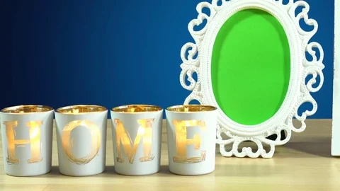 White shabby chic photo framse with green screen and burning home candles on Stock Footage