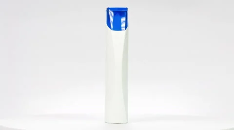 White shampoo bottle with blue cap close up rotation and white background. Stock Footage 61167626