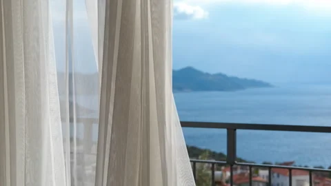 White sheer curtains blowing in the wind with sea view Stock-Footage 329583791