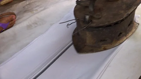 White sheet being ironed by a rusty iron Stock Footage 107625741