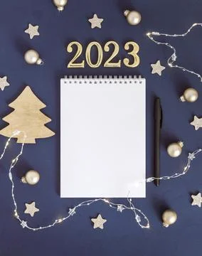White sheet of notebook with pen on blue table. Concept planning, wish list for Stock Photos