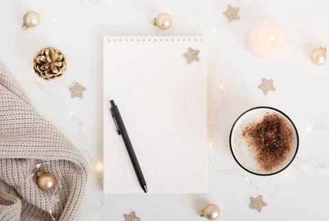 White sheet of notebook with pen on white table with cup of cocoa or coffee.. Stock Photos