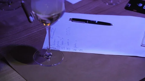 A white sheet with notes and a pen lies on the table. Stock Footage 129112859