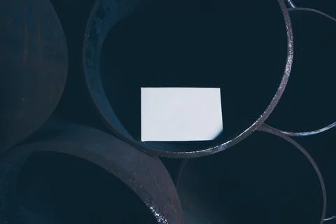 White sheet of paper inside a large iron pipe Фото