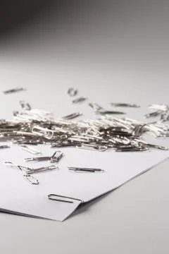 White sheet of paper for notes and paper clip Stock Photos