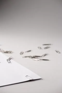 White sheet of paper for notes and paper clip Stock Photos