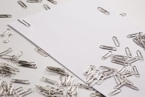 White sheet of paper for notes and paper clip Stock Photos