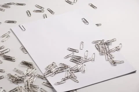 White sheet of paper for notes and paper clip Stock Photos
