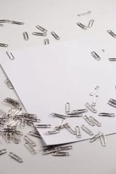 White sheet of paper for notes and paper clip Stock Photos