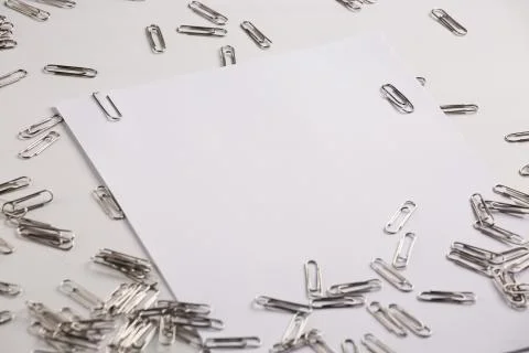 White sheet of paper for notes and paper clip Stock Photos
