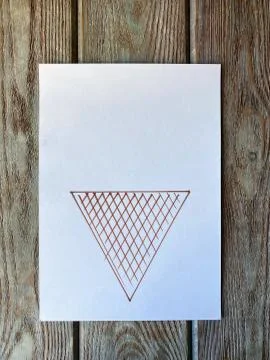 On a white sheet of paper, a triangle is drawn, for future ice cream, Stock Photos