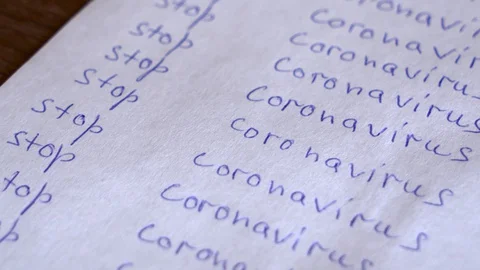 A white sheet spray-painted with the words "Stop the coronavirus" Stock Footage 129190796