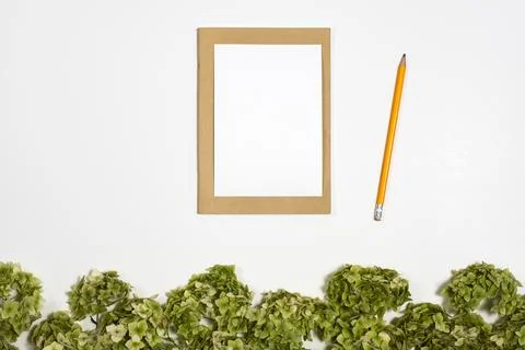 White sheet under on notebook next to a pencil lie on a background with a g.. Stock Photos