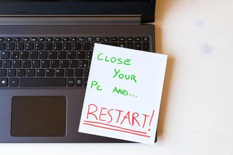 White sheet with the words "close your pc and ... restart!" Stock Photos