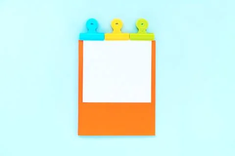 A white sheet for writing on an orange notebook Stock Photos