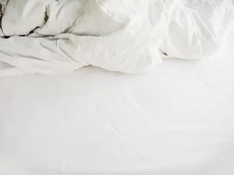 White sheets and blankets after use, Wrinkled and disorganized. Stock Photos
