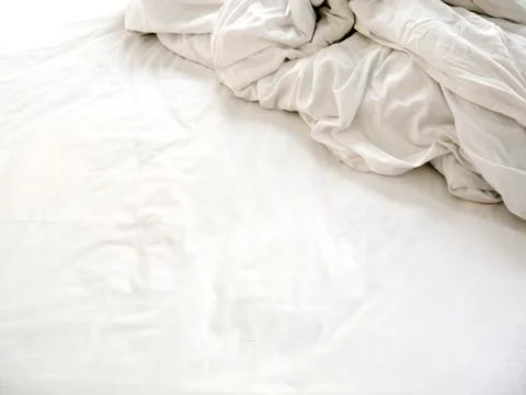 White sheets and blankets after use, Wrinkled and disorganized. Stock Photos