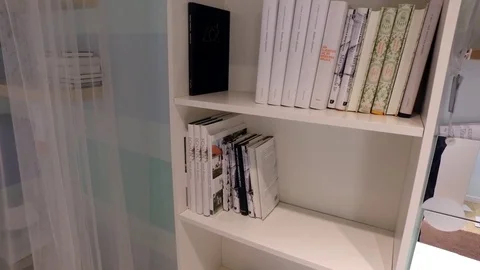 White shelf with books Stock Footage 79194801