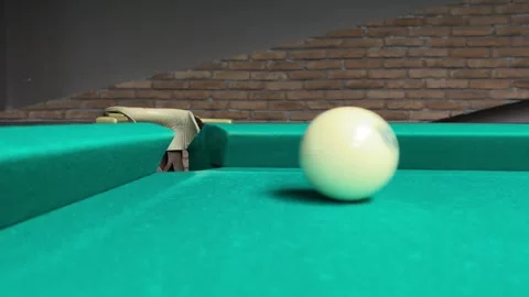 White shiny ball rolls into corner pocket of green pool table Stock Footage 256946385