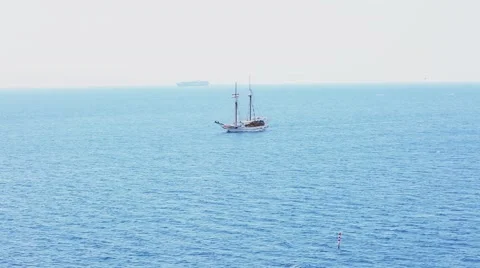 White ship with large masts against a beautiful blue Sunny sea Stock Footage 52375461