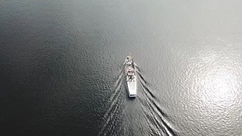 A white ship is moving quickly along the water surface of the river. Stock Footage 136232674