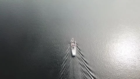 A white ship is moving quickly along the water surface of the river. Stock Footage 136232706