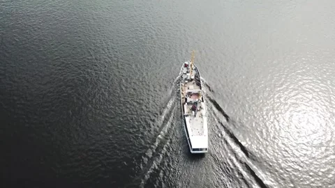 A white ship is moving quickly along the water surface of the river. Stock Footage 136343295
