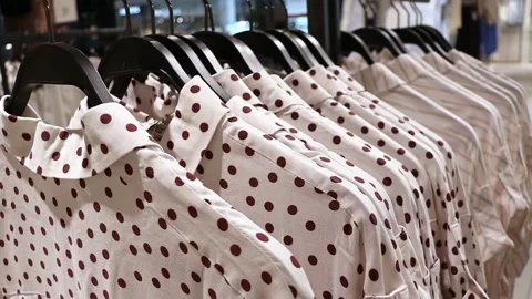White shirts with a pattern on a hanger in a store. Stock-Footage 242619589