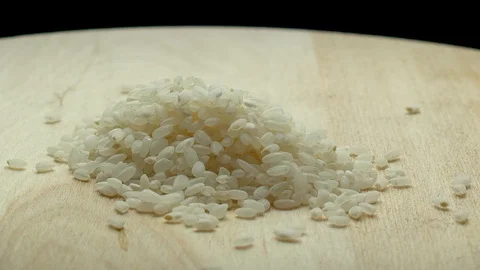 White short grain rice rotates on a wooden board 스톡 동영상 117315494