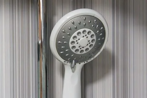 White shower head mounted on chrome pole Stock Photos